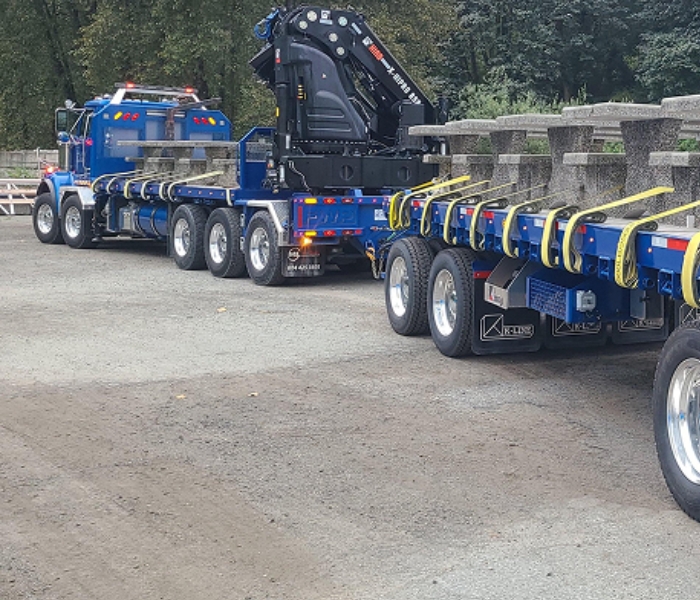 Truck delivering precast concrete picnic tables to project site
