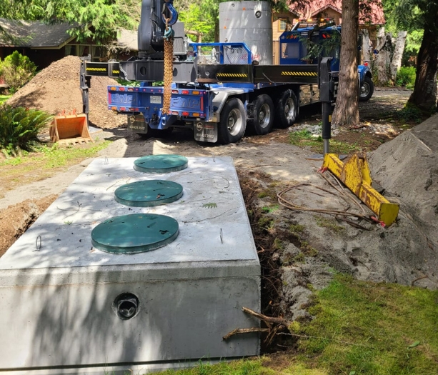 Precast concrete septic tank with access lids installed on site